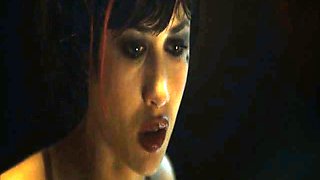 Olga Kurylenko naked hanging by her arms as a guy uses a