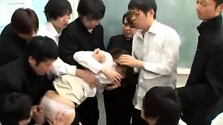 An Asian teen in a schoolgirls uniform is sitting on the