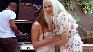 Two smallish blonde girls share a ebony man in bed with