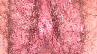 Creamy juices dripping in slowmotion from inside wife's hairy bush closeup