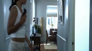 Mia Kirshner crying out loudly and moaning as she sits on a