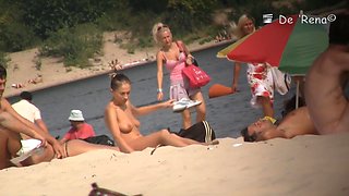 Pretty chick with natural boobs eating watermelon lying on the beach
