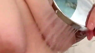 The Redhead Slut Masturbates Her Pussy with the Shower and Enjoys I