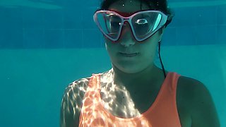Whorish red head Micha Gantelkina gets naked under the water and performs her pussy closeup