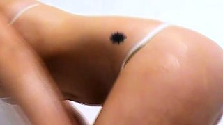 Lisa oils up her body while in the shower