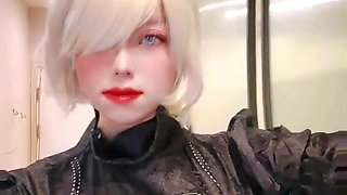 2B cosplayer stimulates her fat cock while deepthroats too deeply that bursts into tears.