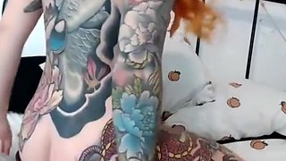 gorgeous tattooed redhead proudly shows pierced tits